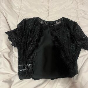 Black open back body suit, with lace sleeves. Size medium never worn.